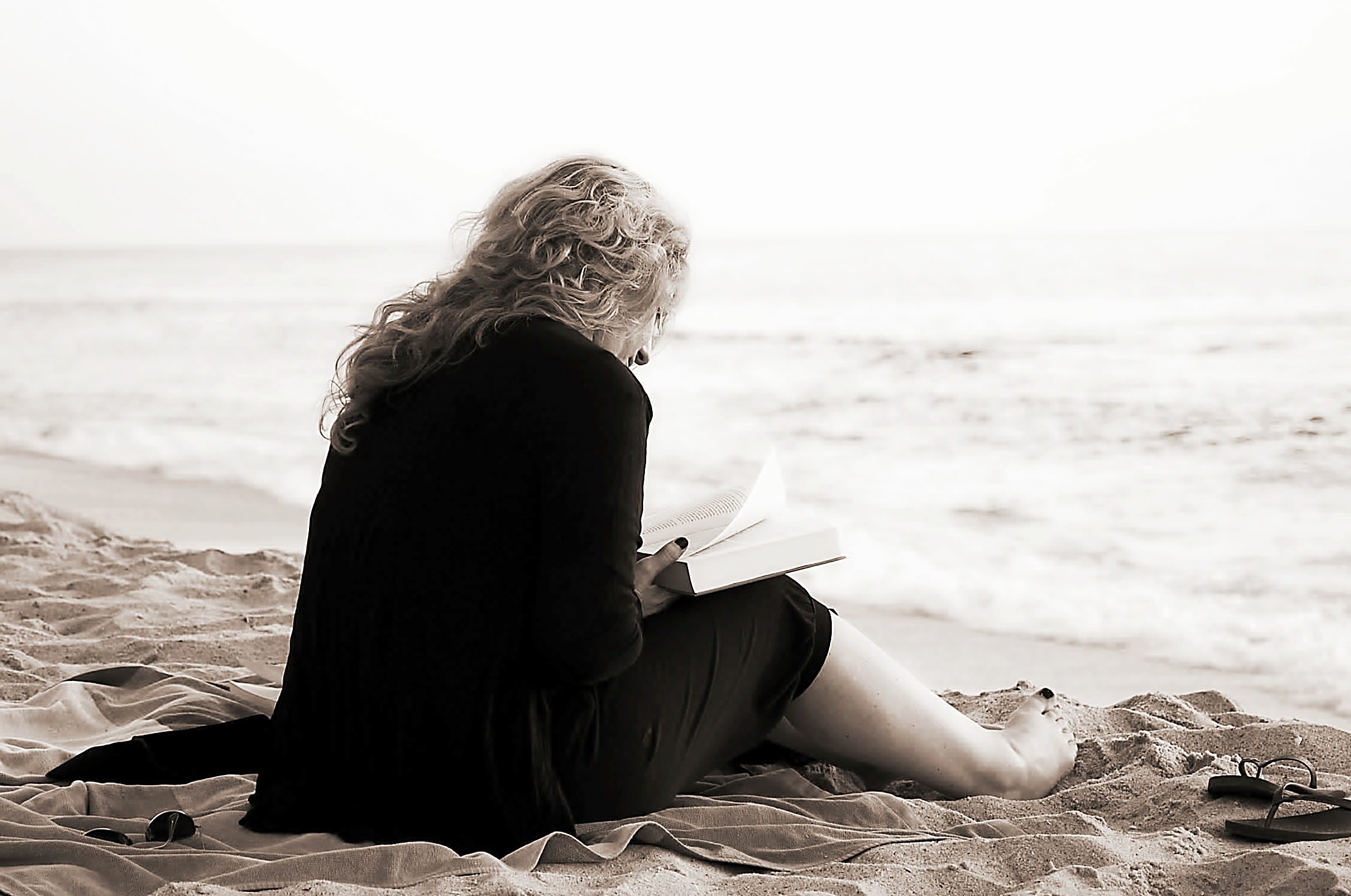 Women read book on the seashore